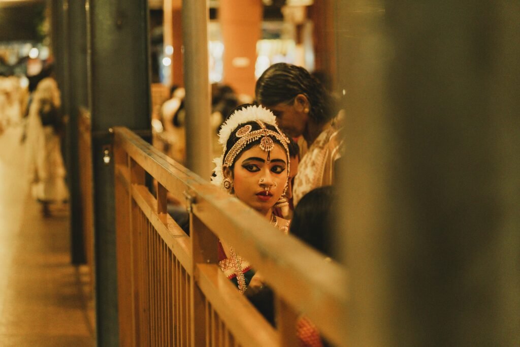 A young woman in traditional dance attire at Guruvayur, Kerala. Capturing cultural essence.